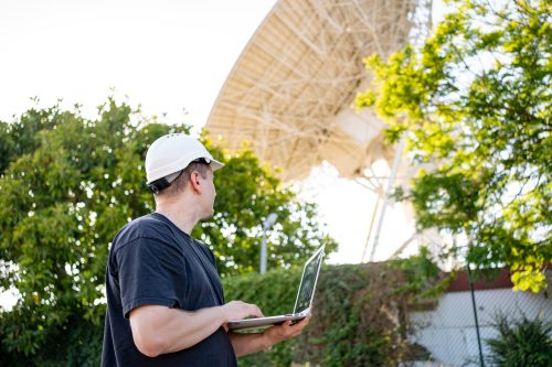 Engineer looking earth based astronomical radio telescope